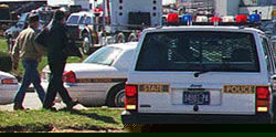 State Trooper escorts Kiehl to waiting police car.